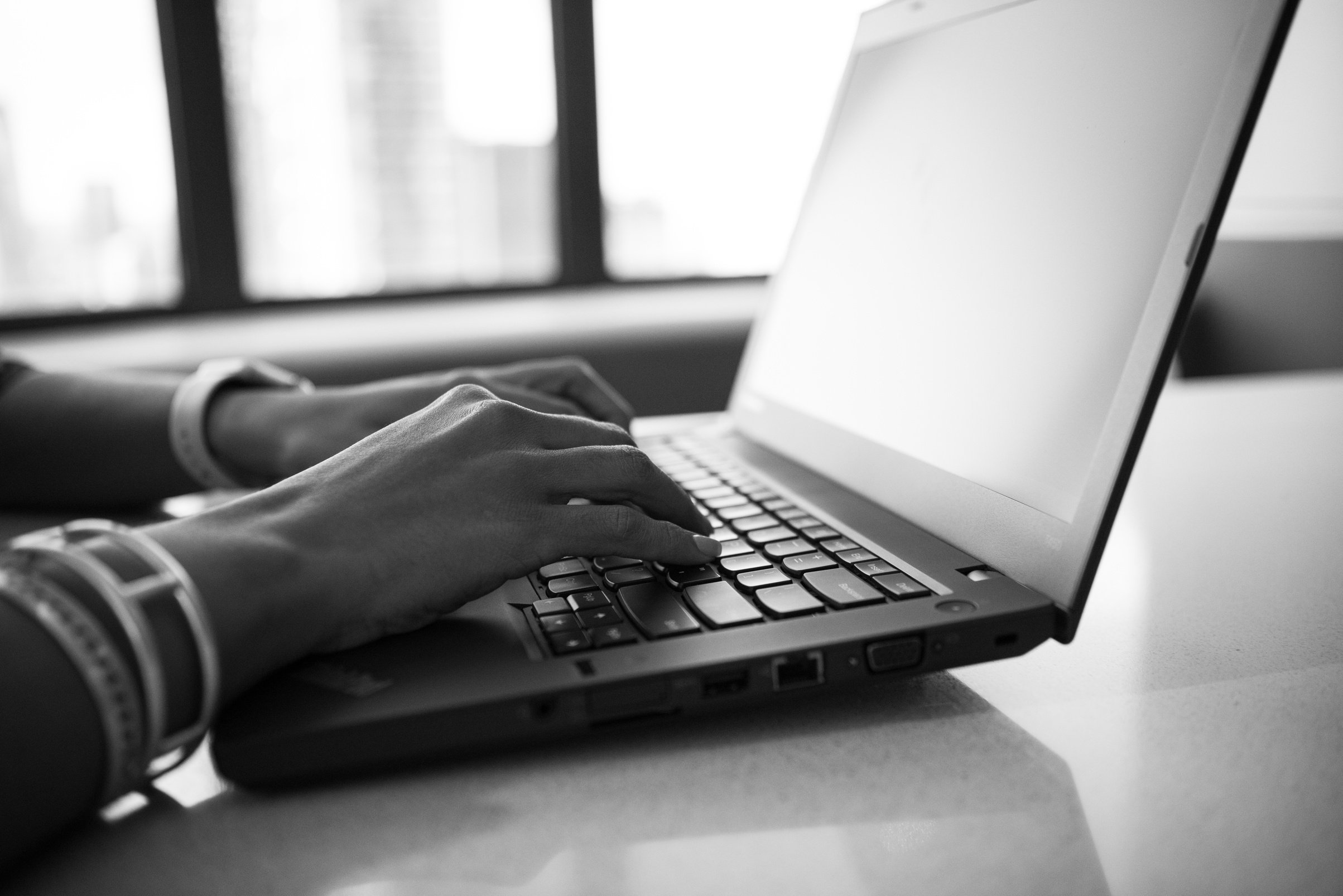 Grayscale Photography of a Woman Working in Front of Laptop